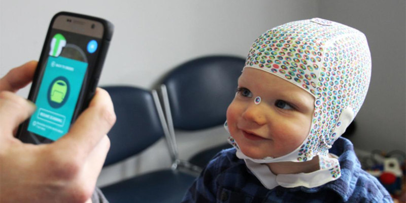 A toddler having thier head scanned