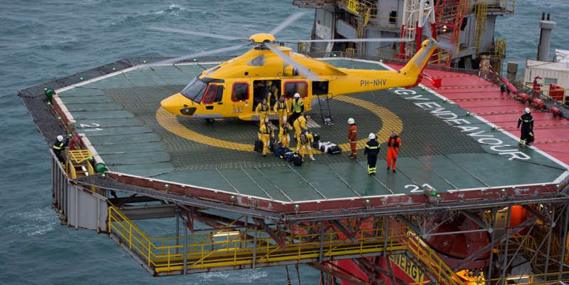 A helicopter landing on an oil rig
