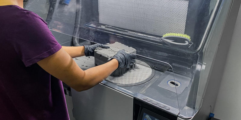 A Selective Laser Sintering 3D printer in operation