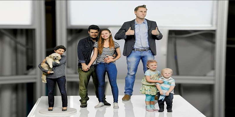 A family group pictured on a 3D printer bed