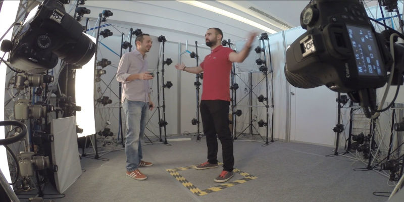 A man in a room getting a 3D Body Scan